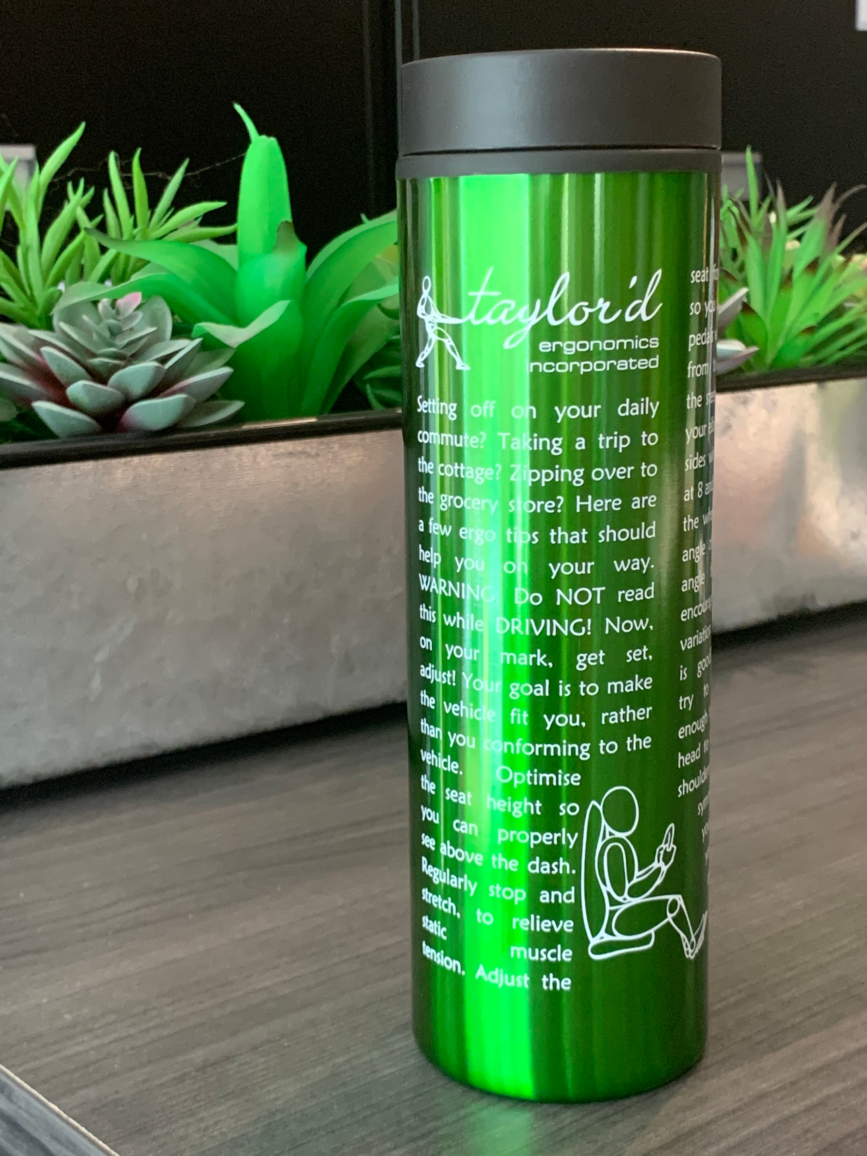 image of bright green travel tumbler with imprint featuring tips for ergonomic driving